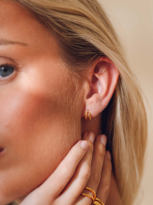 dainty two prong clicker huggie on ear