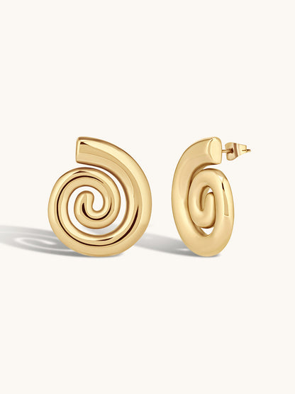 Gold spiral earrings on a white background