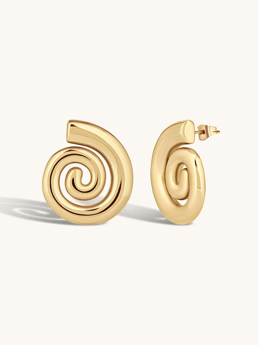 Gold spiral earrings on a white background