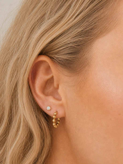 delicate gold rounded opal stud on ear