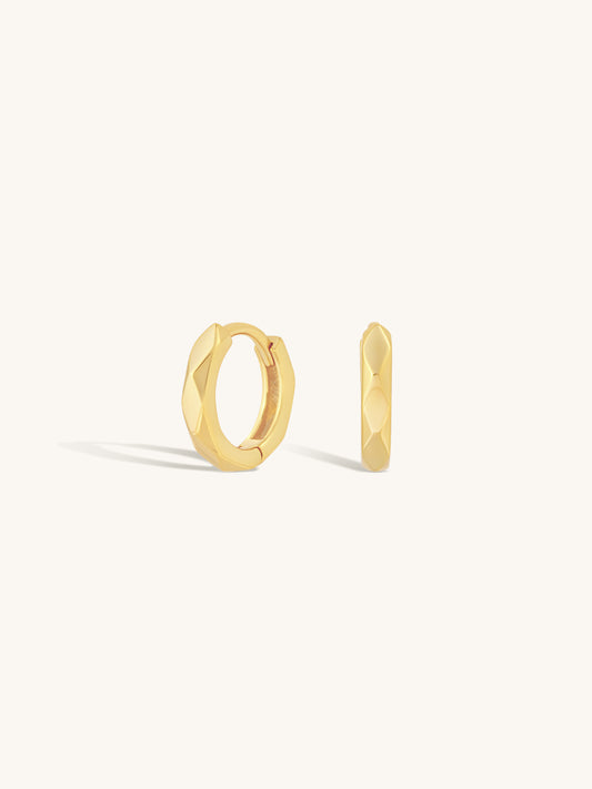 faceted gold clicker huggies on white background