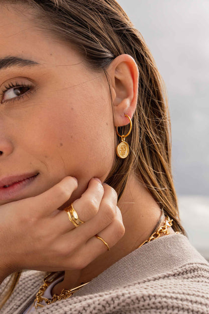 gold-hoops-hamsa-hand-statement-earrings-on-body-angled